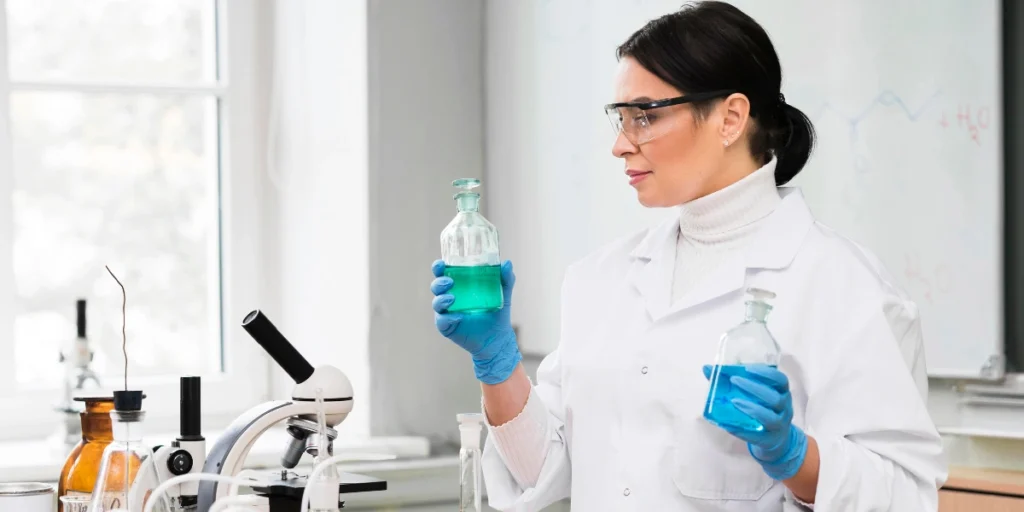 Female scientist testing chemical solutions – Third Party Manufacturer in Pakistan.