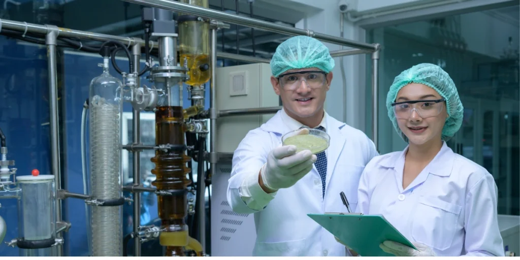 实验室人员依据危险化学品安全法规范操作化学设备并展示检测样品