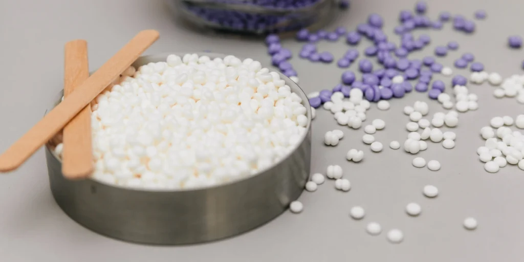 Nitrocellulose Supplier in Pakistan displaying industrial pellets and raw chemical materials for manufacturing use